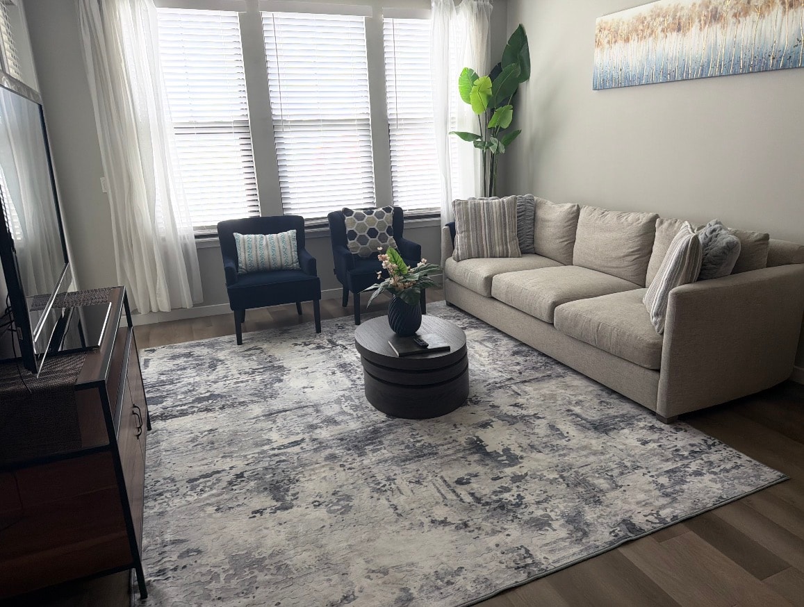 Modern living room with grey sofa and navy accent chairs
