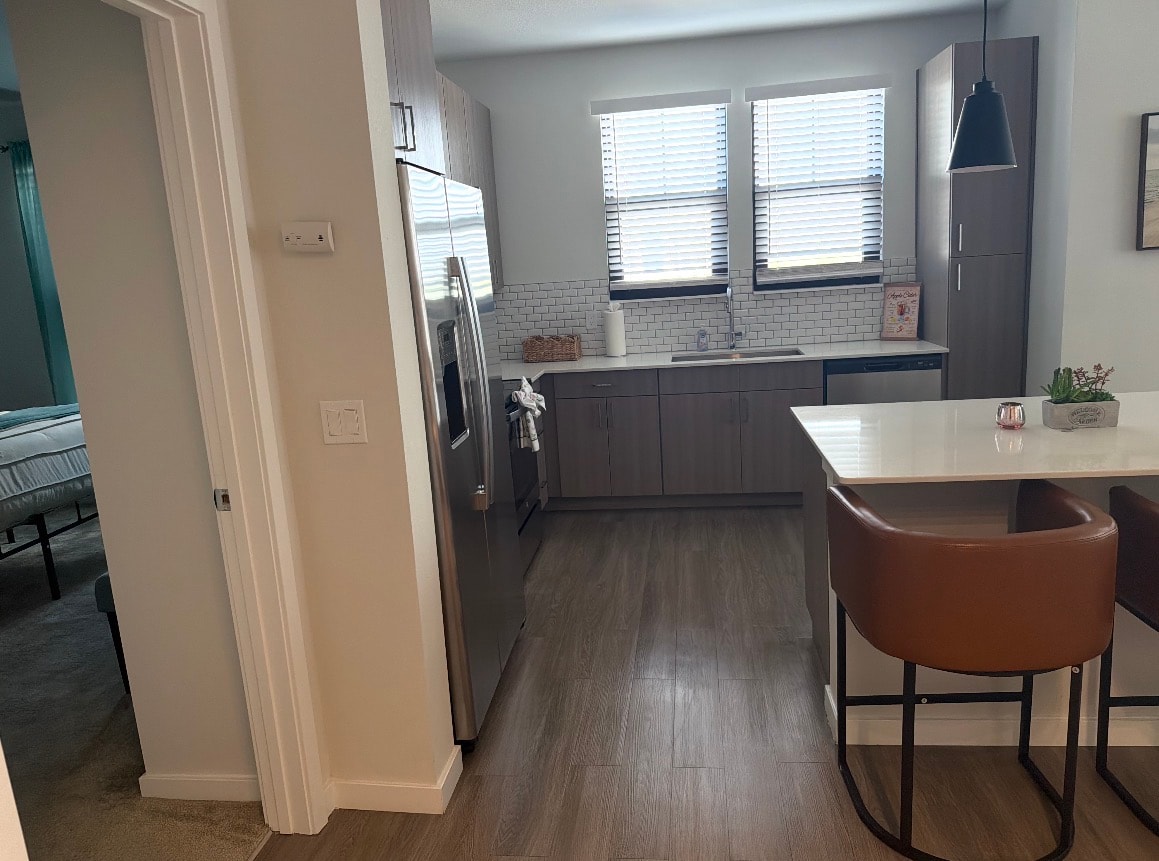 Modern kitchen with grey cabinetry and island bar seating